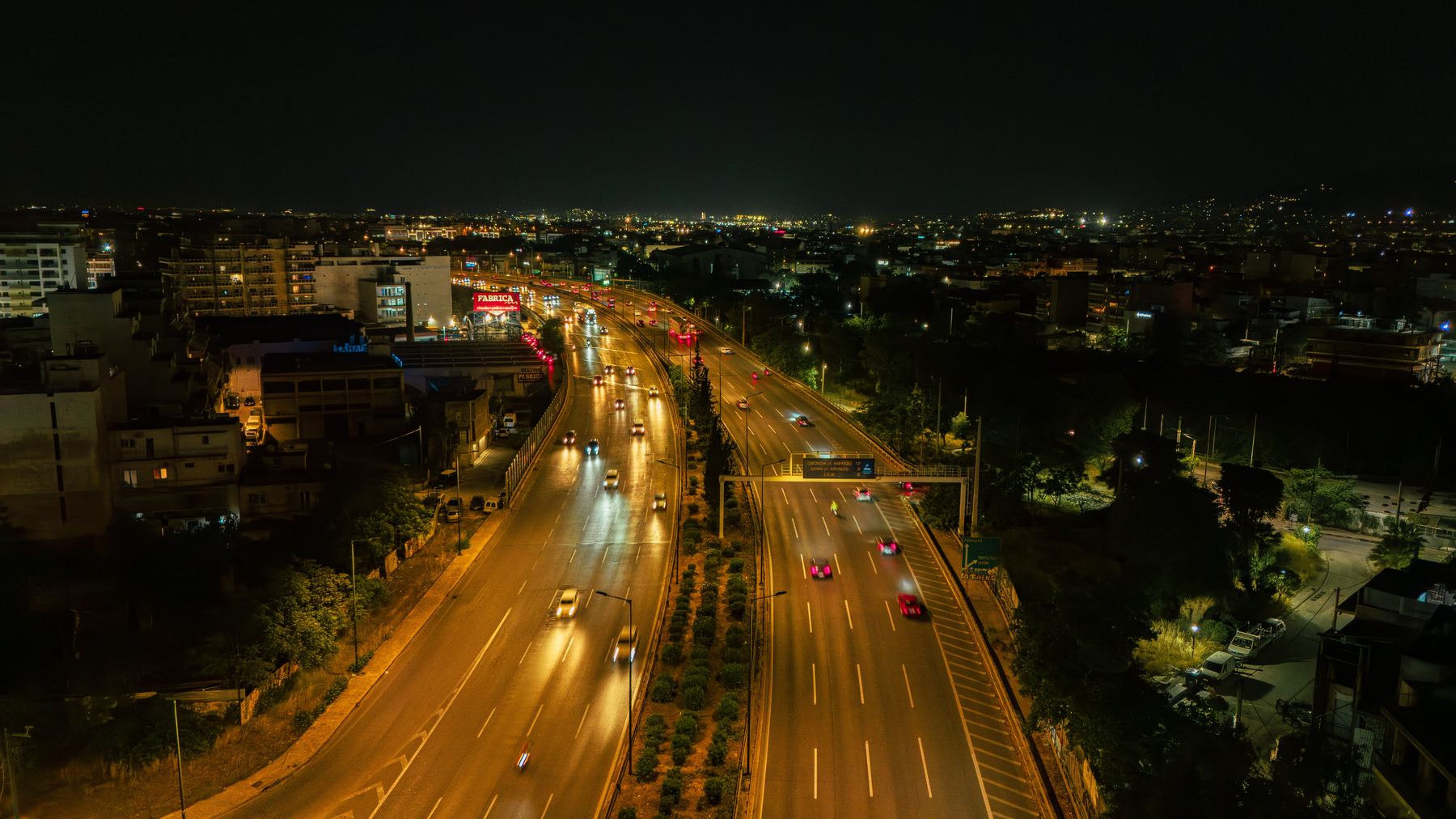 Athens from the air at night, headlights running through the city